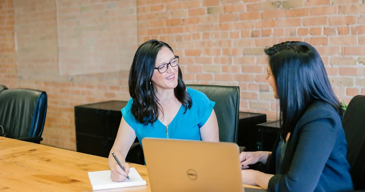 Two women talking through an issue across a table