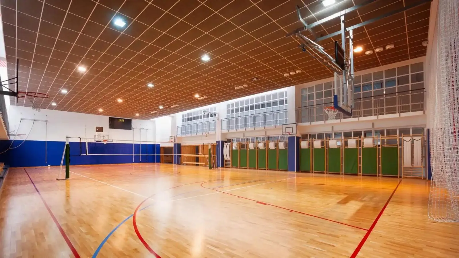 Empty school gymnasium with a wood floor